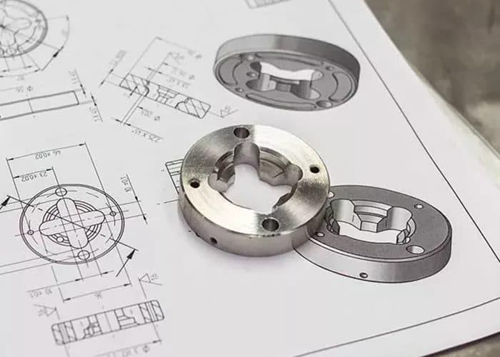 Milled part sitting on the drawing it was cut from