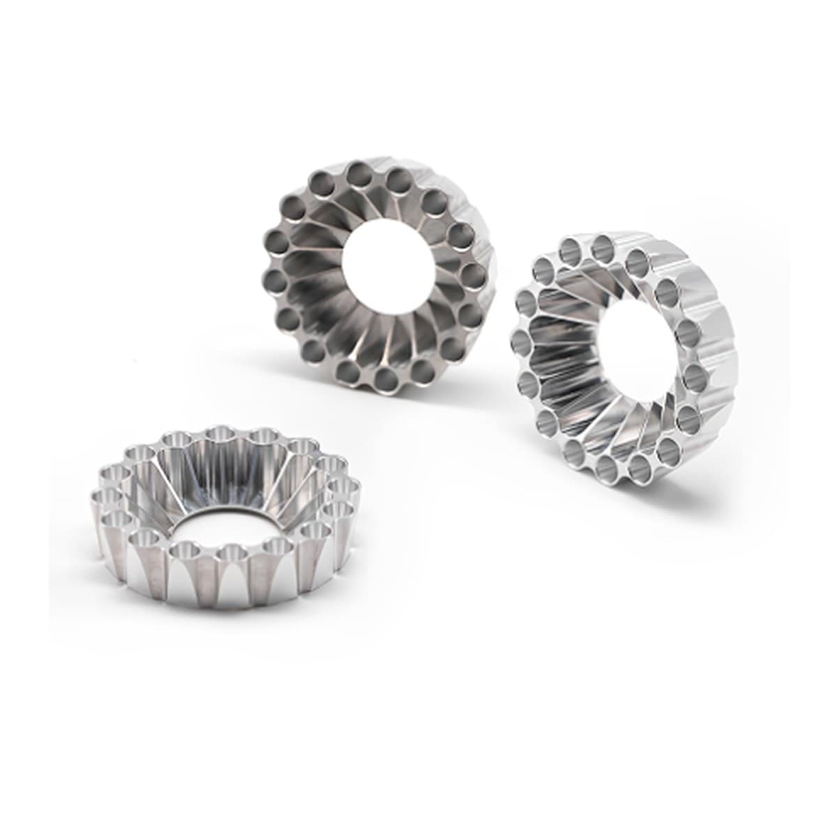 Machined circular medical components on a white background